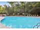 Large swimming pool lined with lounge chairs and lush landscaping at 900 River Vista Dr, Atlanta, GA 30339