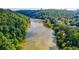 Scenic aerial view of the river winding through a lush green forest and adjacent to the neighborhood at 900 River Vista Dr, Atlanta, GA 30339