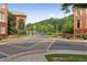 Street view of the neighborhood featuring brick townhomes and well-maintained landscaping at 900 River Vista Dr, Atlanta, GA 30339