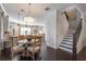 Dining room features a round table, wood chairs, and views of the kitchen and stairway at 1384 Doublegate Dr, Brookhaven, GA 30319