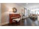 Open living room with a piano, hardwood floors, and view to the kitchen and dining area at 1384 Doublegate Dr, Brookhaven, GA 30319