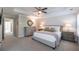 Large main bedroom with neutral carpeting, a ceiling fan, and a walk-in closet at 1384 Doublegate Dr, Brookhaven, GA 30319