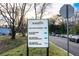 This sign shows directions to parking for the dog park, playground and IDD service center at 1384 Doublegate Dr, Brookhaven, GA 30319