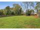 Expansive backyard with lush green grass, mature trees, and a wooden fence providing privacy at 1865 Lochlomand Se Ln, Smyrna, GA 30080