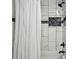 Beautiful white tile lined shower with a built-in shelf and a white shower curtain at 1865 Lochlomand Se Ln, Smyrna, GA 30080