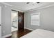 Bedroom features hardwood floors and a barn door leading to the en suite bathroom at 1865 Lochlomand Se Ln, Smyrna, GA 30080