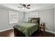Cozy bedroom featuring hardwood floors, a ceiling fan and neutral-toned walls for a relaxing ambiance at 1865 Lochlomand Se Ln, Smyrna, GA 30080