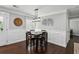 Cozy dining area with a dark wood table, hardwood floors, and wainscoting, ideal for Gathering meals at 1865 Lochlomand Se Ln, Smyrna, GA 30080