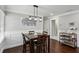 Charming dining area with hardwood floors, wainscoting, and a stylish chandelier, perfect for entertaining at 1865 Lochlomand Se Ln, Smyrna, GA 30080