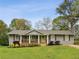 Charming single story home with a covered front porch and mature trees on a well-manicured lawn at 1865 Lochlomand Se Ln, Smyrna, GA 30080