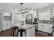 Modern kitchen with stainless steel appliances, granite countertops, a center island, and laundry area at 1865 Lochlomand Se Ln, Smyrna, GA 30080