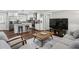 Inviting living room with hardwood floors, a comfortable sofa, and an adjacent modern, white kitchen at 1865 Lochlomand Se Ln, Smyrna, GA 30080