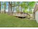 A view of the backyard with a spacious wooden deck and verdant green lawn at 2199 Summertown Dr, Norcross, GA 30071