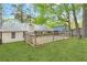 Exterior with a spacious backyard, featuring a wooden deck and lush green lawn at 2199 Summertown Dr, Norcross, GA 30071