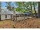Expansive backyard with a wooden deck, surrounded by lush trees and natural landscape at 2199 Summertown Dr, Norcross, GA 30071