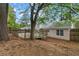 Spacious backyard features a large wooden deck, mature trees, and a privacy fence at 2199 Summertown Dr, Norcross, GA 30071