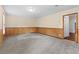 Basement room featuring carpet and wood paneling, perfect for versatile use and comfort at 2199 Summertown Dr, Norcross, GA 30071