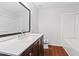Bathroom featuring dark vanity with a white countertop with modern fixtures and a white shower/tub at 2199 Summertown Dr, Norcross, GA 30071