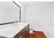 Modern bathroom featuring a white countertop vanity, large mirror, and tub at 2199 Summertown Dr, Norcross, GA 30071