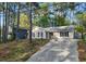 Inviting single-story home with a long driveway and serene setting amongst mature trees in a charming neighborhood at 2199 Summertown Dr, Norcross, GA 30071