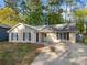 Charming single-story home with a well-maintained lawn and inviting curb appeal nestled under mature trees at 2199 Summertown Dr, Norcross, GA 30071
