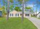 A single-story house with well maintained front lawn and mature trees at 2199 Summertown Dr, Norcross, GA 30071