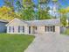 Charming single-story home featuring a well-manicured lawn and a long driveway at 2199 Summertown Dr, Norcross, GA 30071