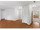 Bright hallway showcasing hardwood floors, fresh paint, and multiple doors leading to various rooms in the house at 2199 Summertown Dr, Norcross, GA 30071