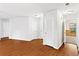Bright hallway featuring wood floors, white walls, and several doorways at 2199 Summertown Dr, Norcross, GA 30071
