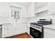 Bright kitchen featuring white cabinets, stainless steel appliances, and a farmhouse sink at 2199 Summertown Dr, Norcross, GA 30071