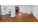 Open-concept living space featuring hardwood floors, stone fireplace, and seamless connection to kitchen area at 2199 Summertown Dr, Norcross, GA 30071