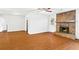 Spacious living room features wood floors, stone fireplace, and access to kitchen at 2199 Summertown Dr, Norcross, GA 30071