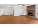 Spacious living room featuring hardwood floors, a stone fireplace, and a back door leading to outdoor space at 2199 Summertown Dr, Norcross, GA 30071