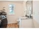 Convenient bathroom features a washer and dryer with new vanity and hardwood floors at , Atlanta, GA 30311