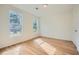 Vacant bedroom featuring new hardwood floors and two windows with a view at , Atlanta, GA 30311