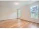 Empty bedroom space with new wood floors and two windows with a natural view at , Atlanta, GA 30311