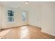 Empty room with new wood flooring, two windows with natural light, and a closet at , Atlanta, GA 30311
