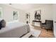 Bright bedroom featuring a large bed, hardwood floors, horse art and a comfortable chair at , Atlanta, GA 30311