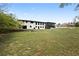 Large, grassy backyard offering ample space and a view of the home's exterior with its screened-in porch at 240 Thornton Dr, Fayetteville, GA 30214