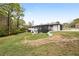 Spacious backyard showing the home's full exterior, including a screened porch and lush green surroundings at 240 Thornton Dr, Fayetteville, GA 30214