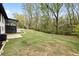 Expansive backyard featuring a well-maintained lawn and surrounded by mature trees, offering privacy and space at 240 Thornton Dr, Fayetteville, GA 30214