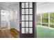 Bathroom and sunroom through a paneled glass door at 240 Thornton Dr, Fayetteville, GA 30214