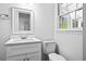 Clean bathroom with a white vanity, quartz countertop, and modern fixtures at 240 Thornton Dr, Fayetteville, GA 30214
