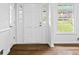 Bright entryway featuring a white door, sidelights, and wood floors at 240 Thornton Dr, Fayetteville, GA 30214