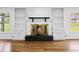 Cozy living room with a stone fireplace and built-in shelving at 240 Thornton Dr, Fayetteville, GA 30214