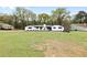 Charming single-story home with a freshly painted white exterior, black shutters, and a well-manicured front yard at 240 Thornton Dr, Fayetteville, GA 30214