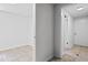 Hallway leading to a bright room with white walls, neutral floors, and three entryways at 240 Thornton Dr, Fayetteville, GA 30214