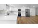 Modern kitchen with white cabinets, quartz countertops, stainless steel appliances, and tile backsplash at 240 Thornton Dr, Fayetteville, GA 30214