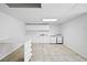 Basement kitchenette includes white cabinets, a sink, and modern appliances, providing convenience and functionality at 240 Thornton Dr, Fayetteville, GA 30214