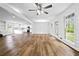 Open-concept living room with wood floors, leading to the kitchen and dining area at 240 Thornton Dr, Fayetteville, GA 30214